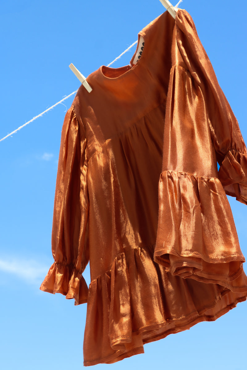 Terracotta dress for girls, with long sleeves and tiered skirt. Label Fiamma Studio, australian sustainable ethical clothing brand.