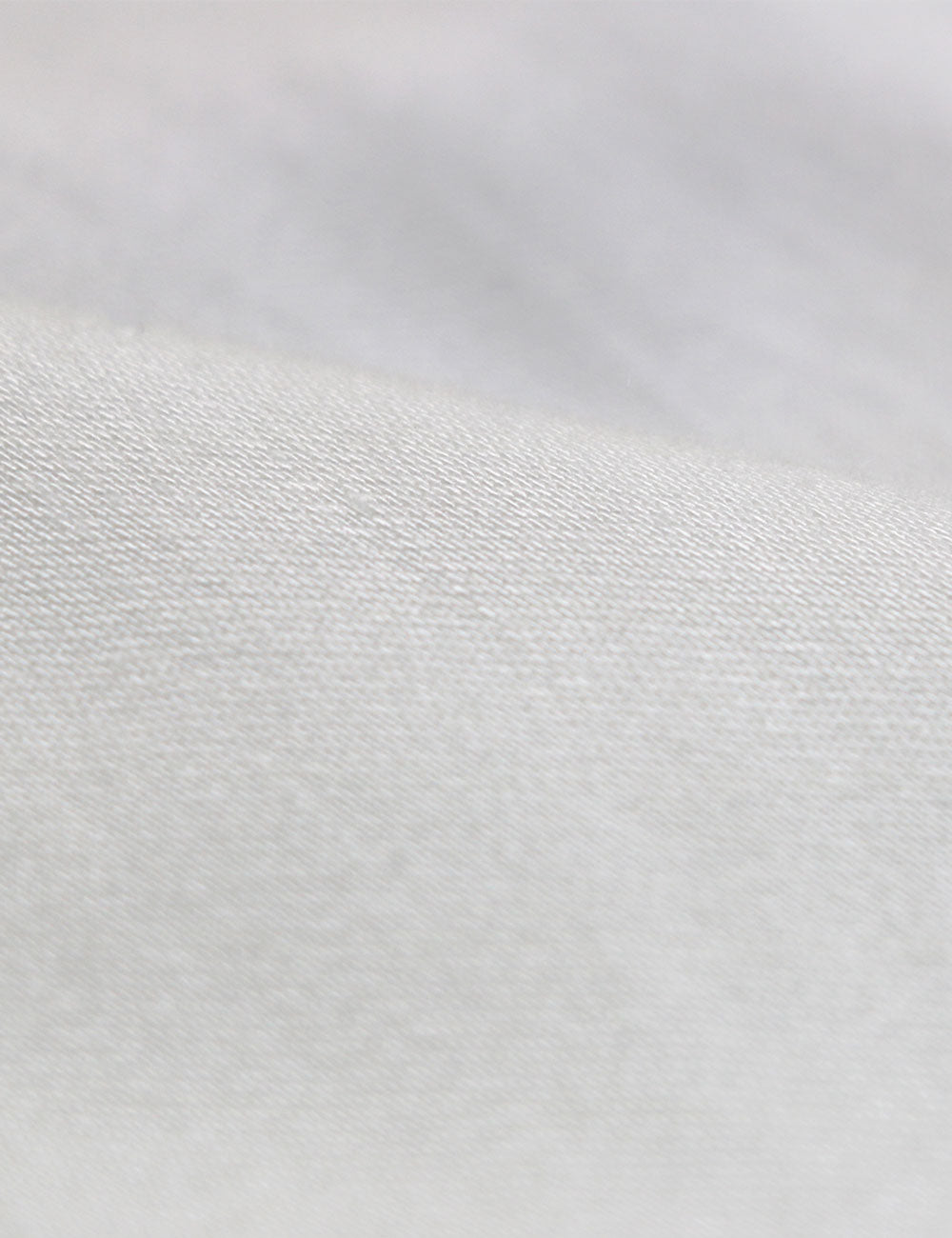 Close-up photograph of bamboo satin fabric for sustainable fashion clothing.