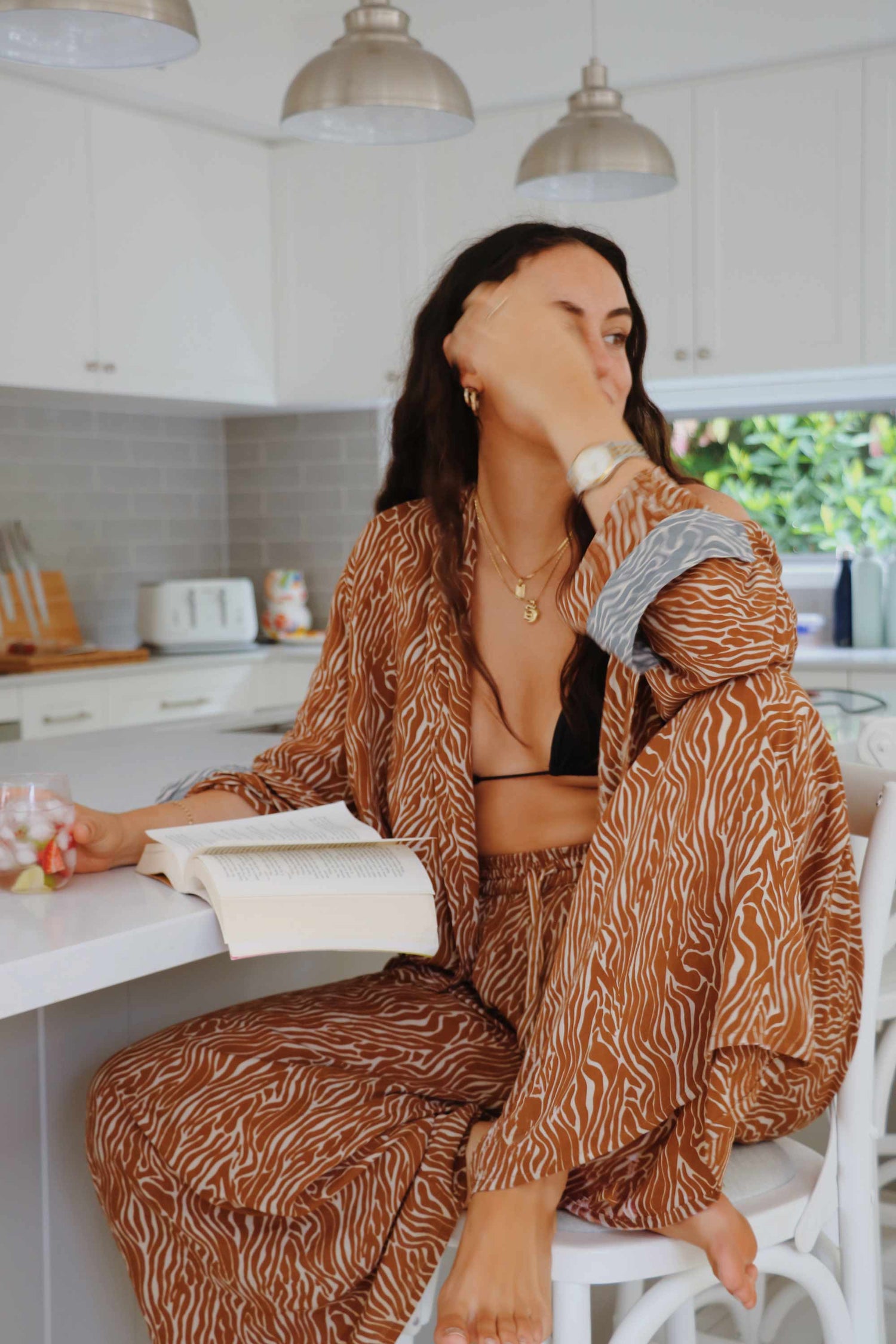 Model wearing sand zebra print set with oversize shirt and wide leg pants.