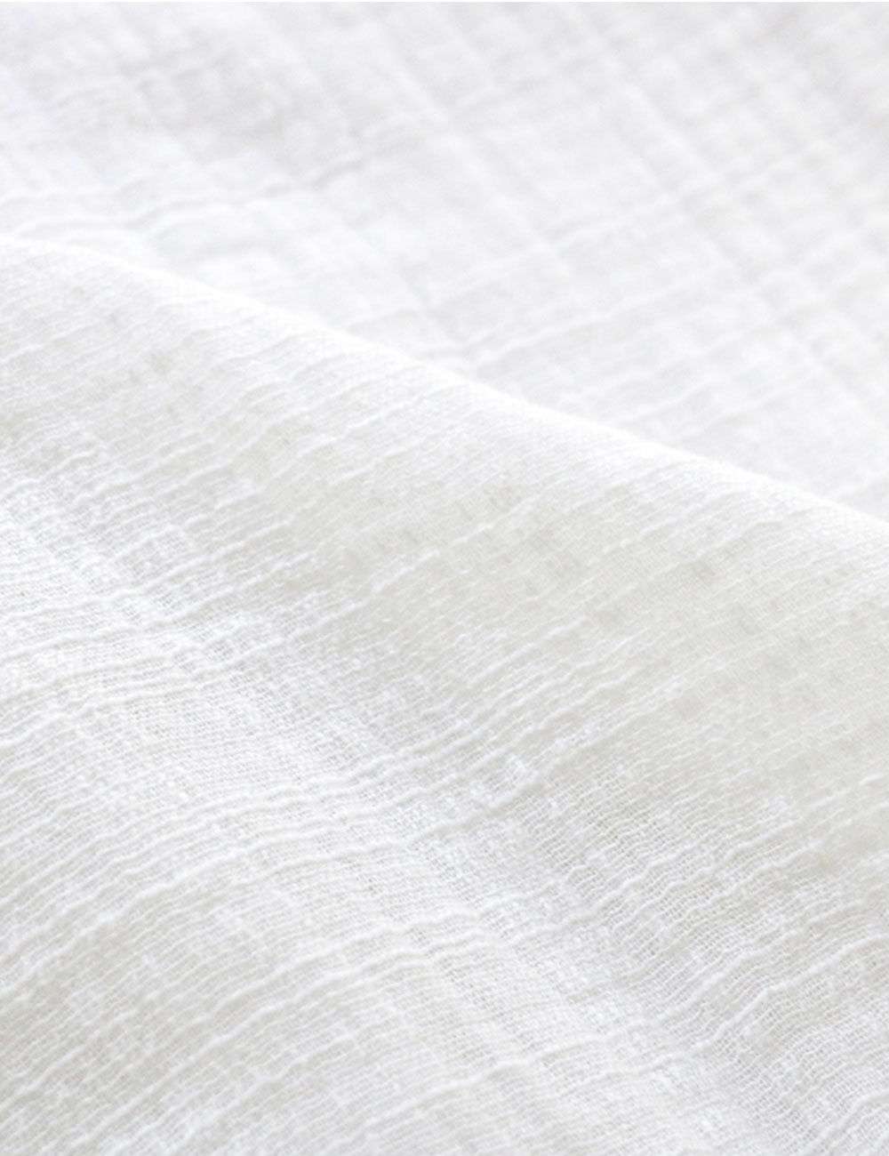 Close-up photograph of cotton gauze fabric for sustainable fashion clothing.