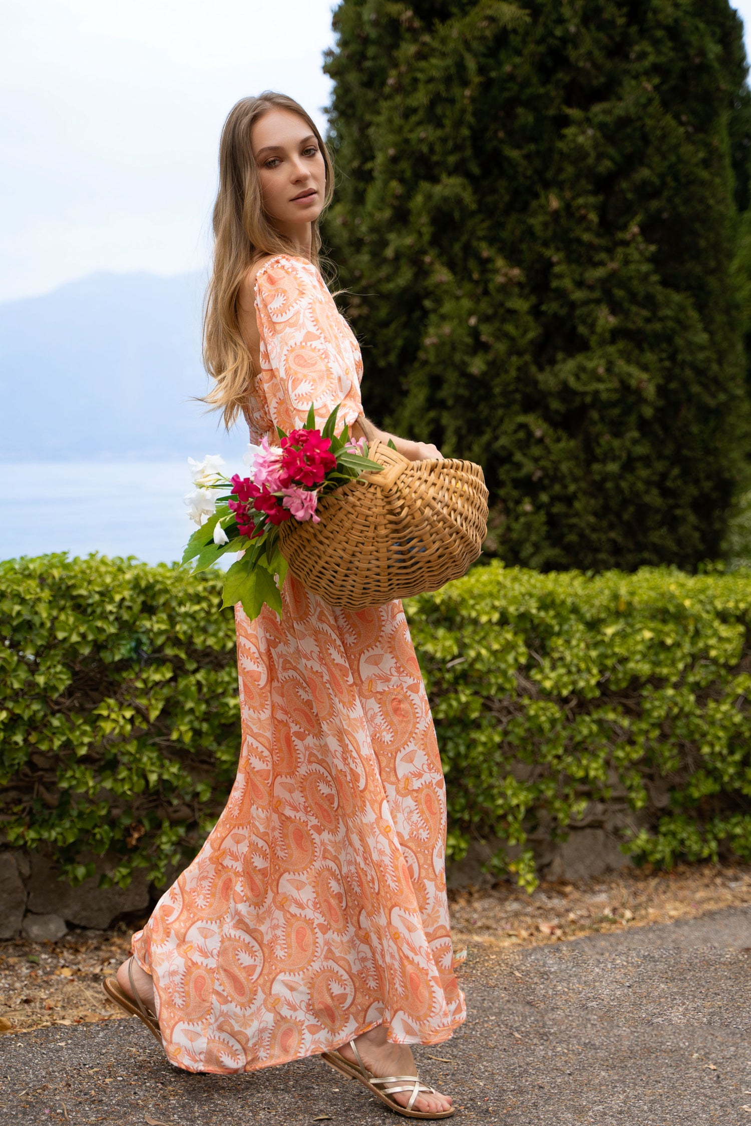 Floral orange maxi dress with puff sleeves, shirred bodice and maxi skirt.