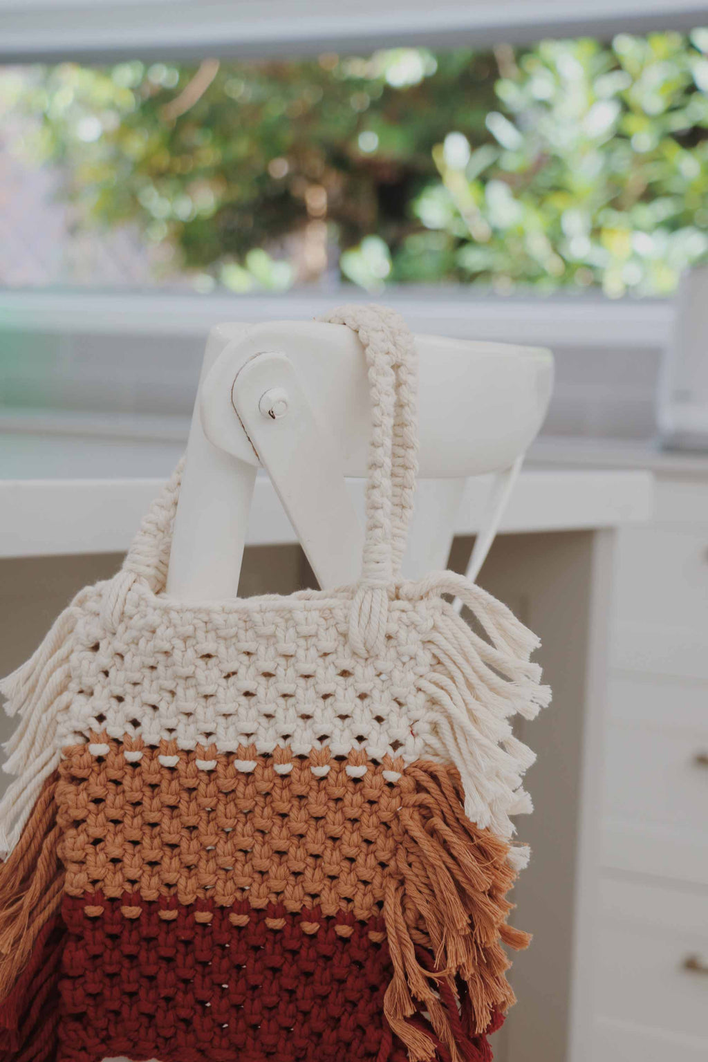 Crochet bag, made with recycled cotton yarn with stripes white, tan and burgundy.