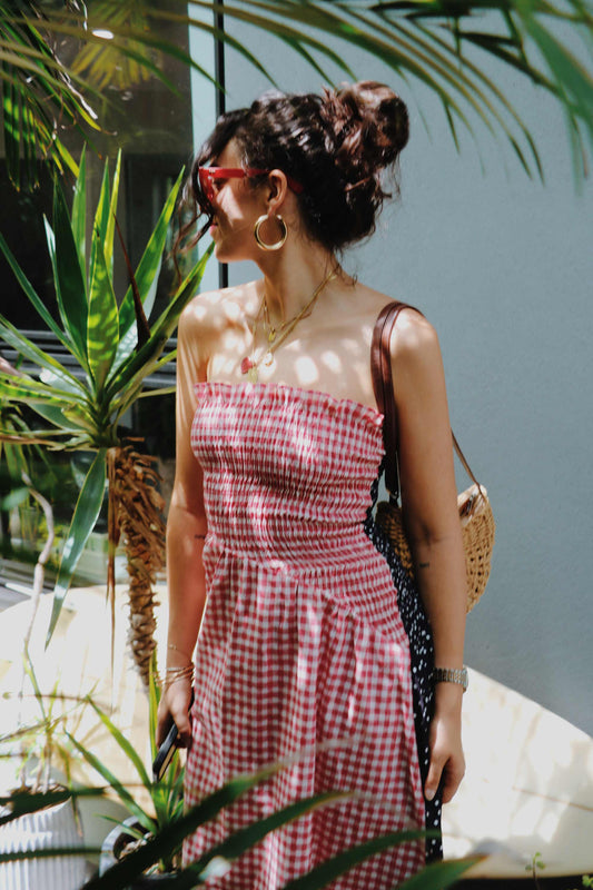 Strapless shirred red gingham midi dress.