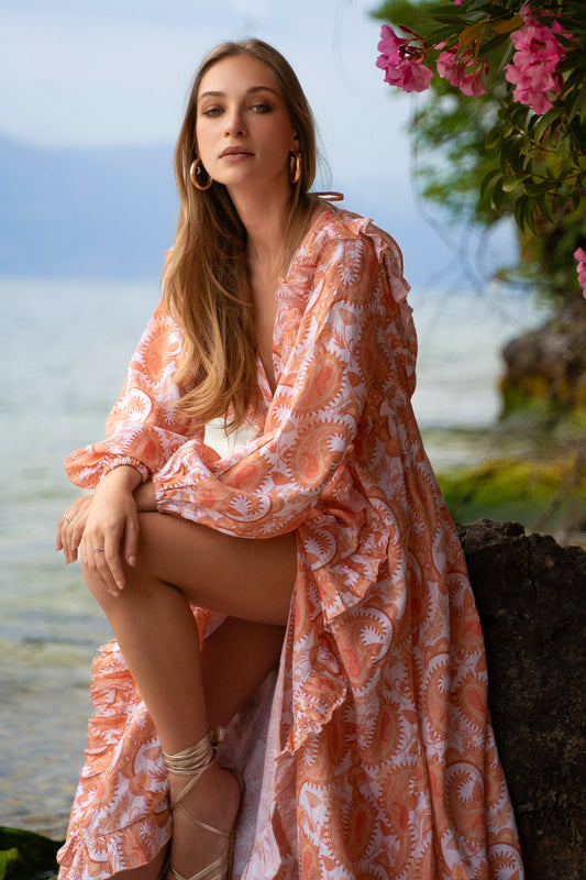 Floral paisley printed orange linen maxi dress, with long puff sleeves, a-line skirt, ruffles and open back.