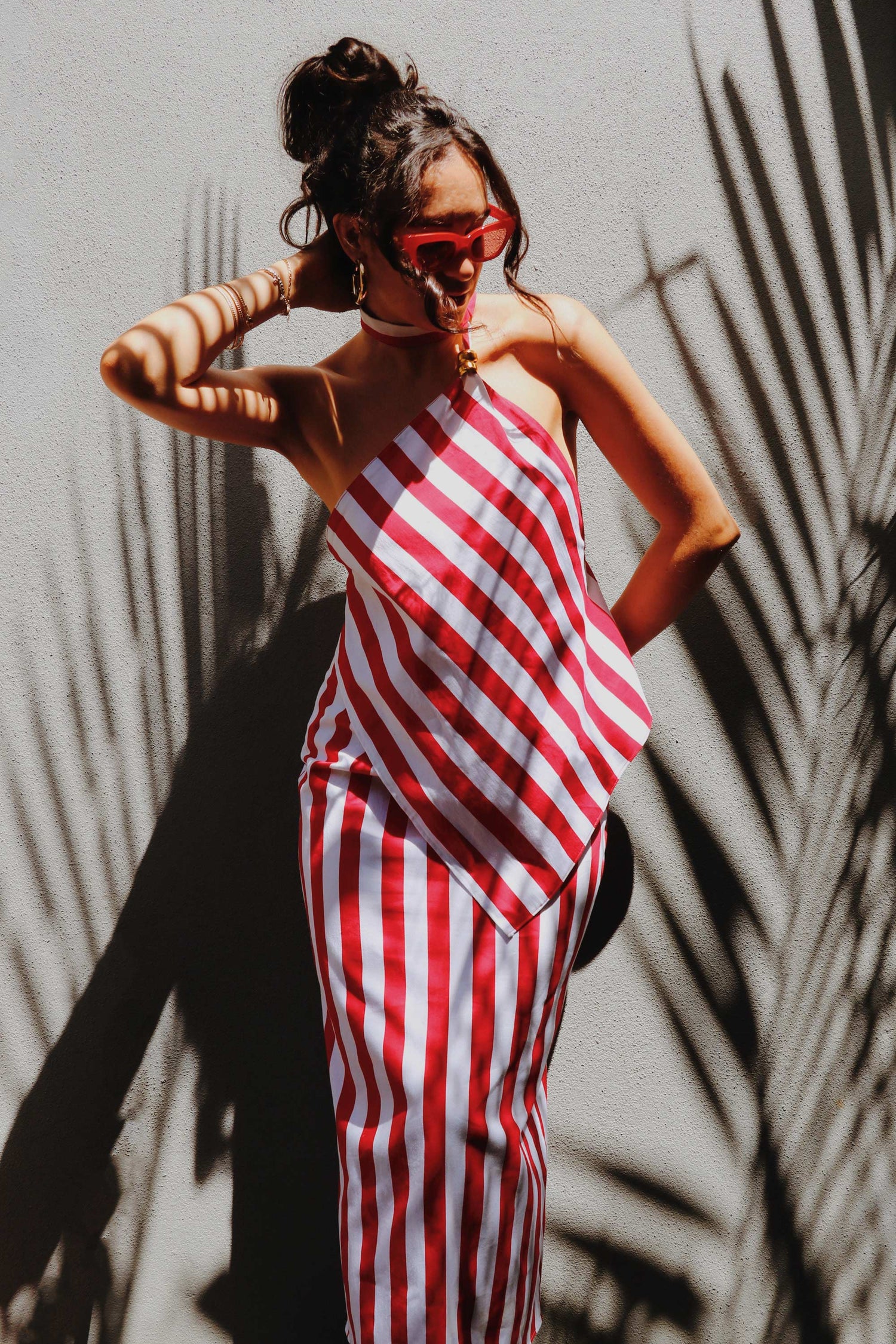 Striped set with pencil skirt, asymmetrical top, red and white stripes and open back.