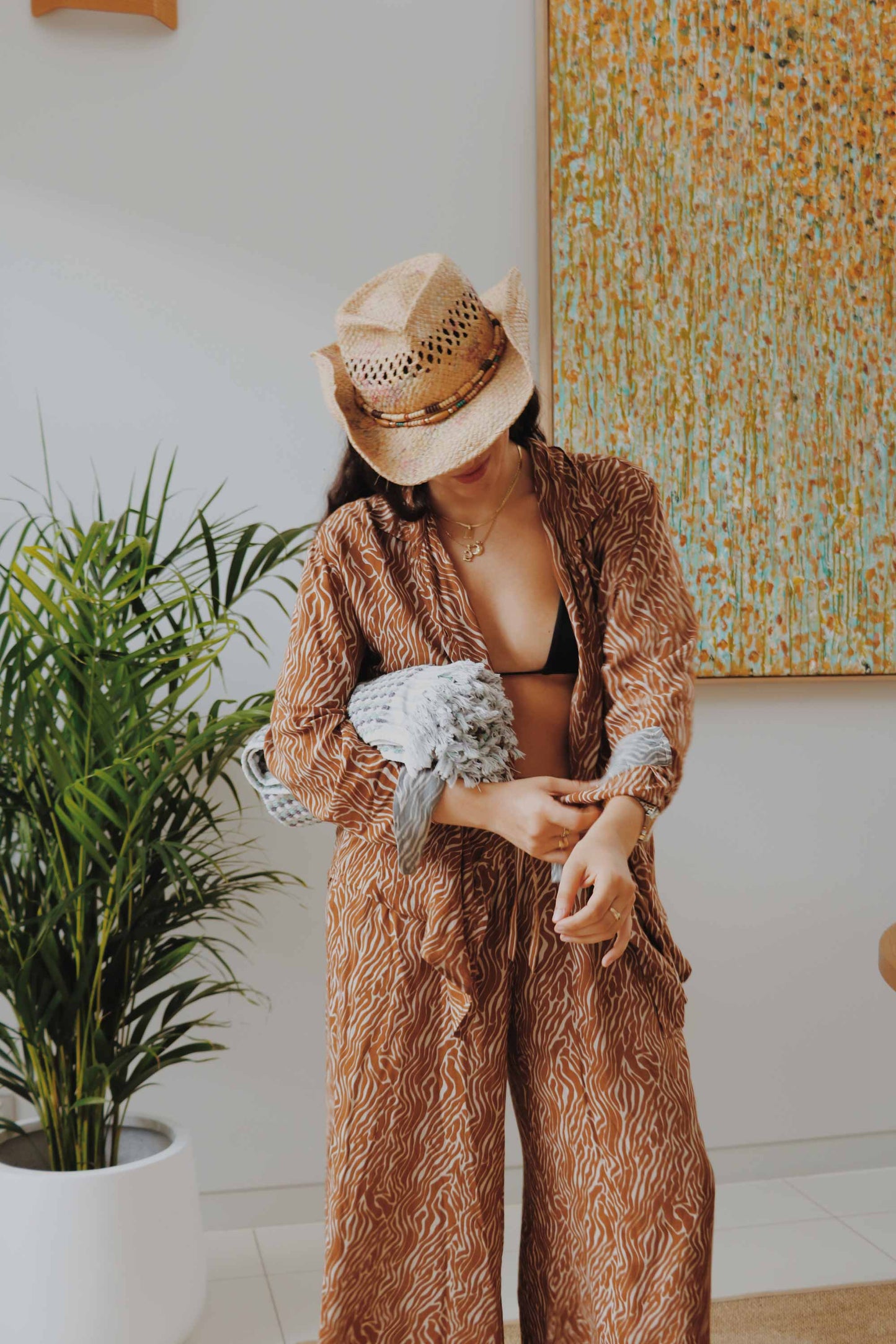 Model wearing sand zebra print set with oversize shirt and wide leg pants.