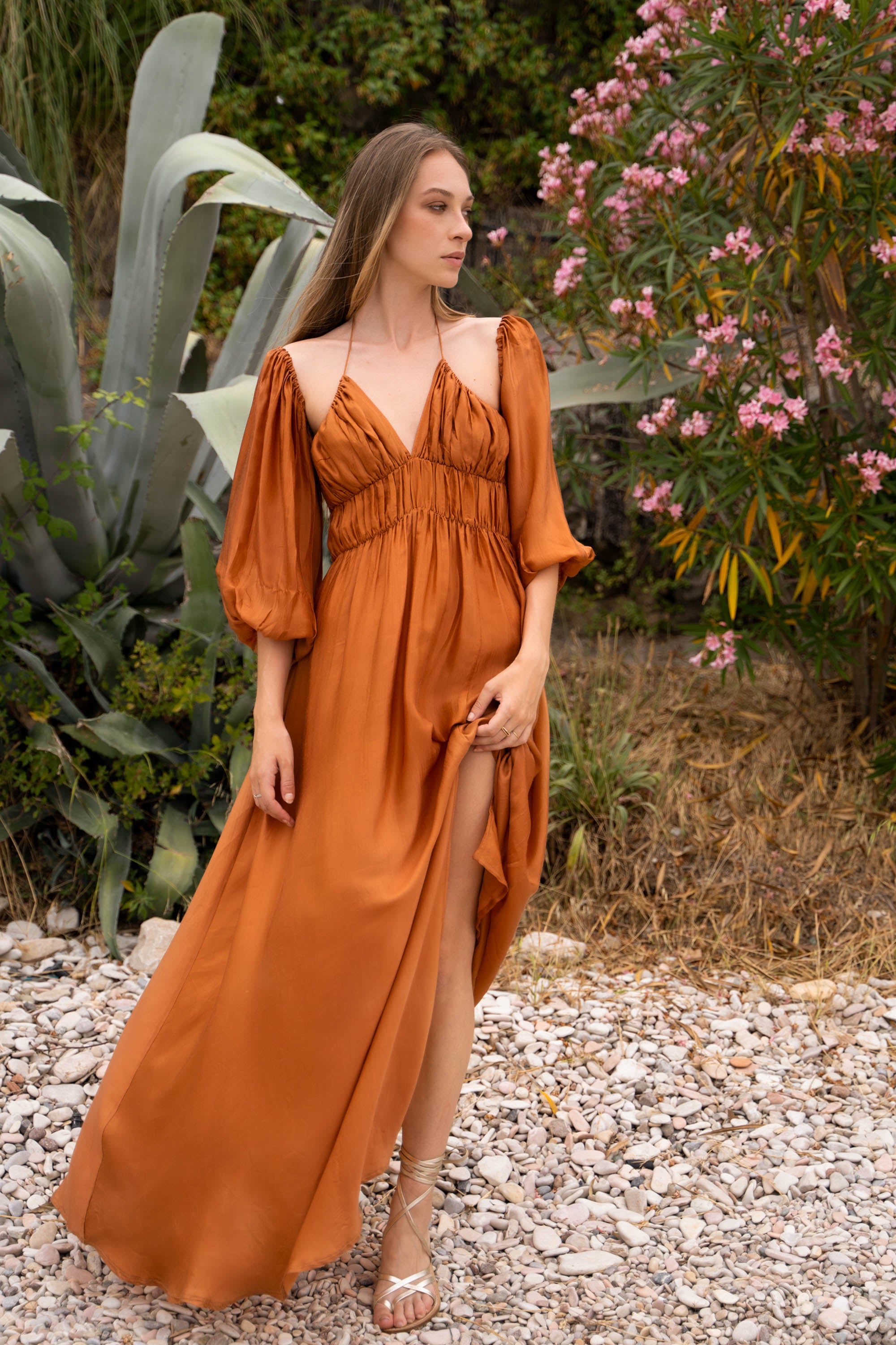 A terracotta maxi dress, with puff sleeves and shirred bust.