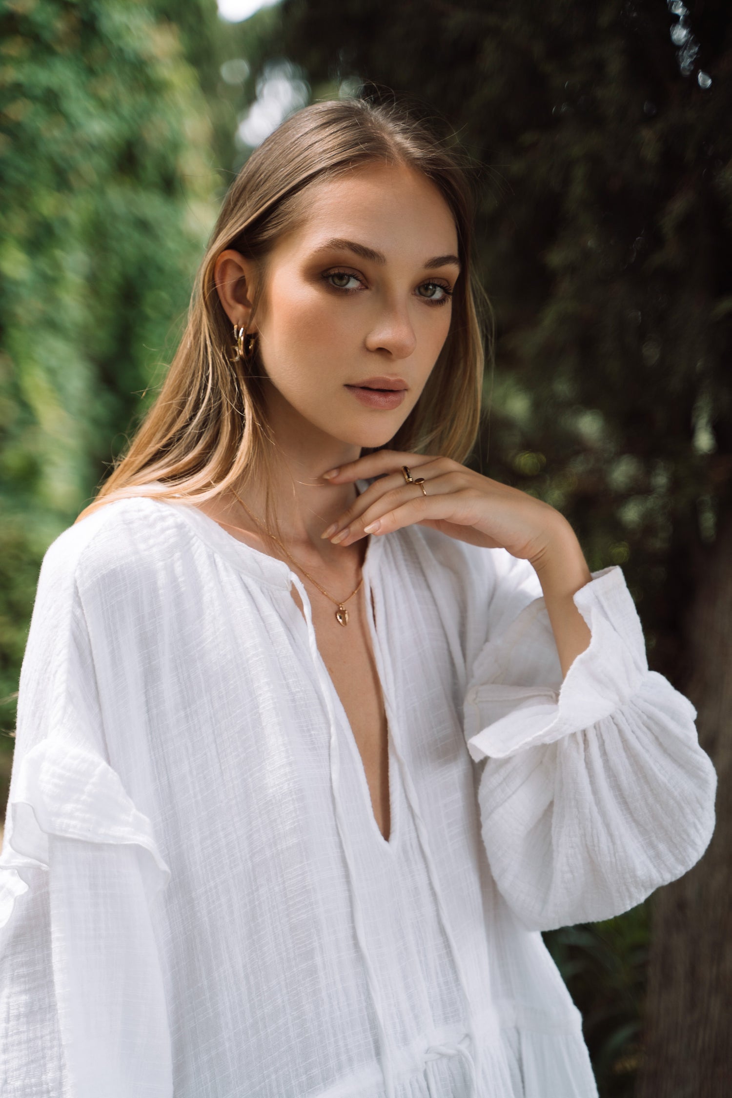 White cotton dress with v-neckline and collar ties.