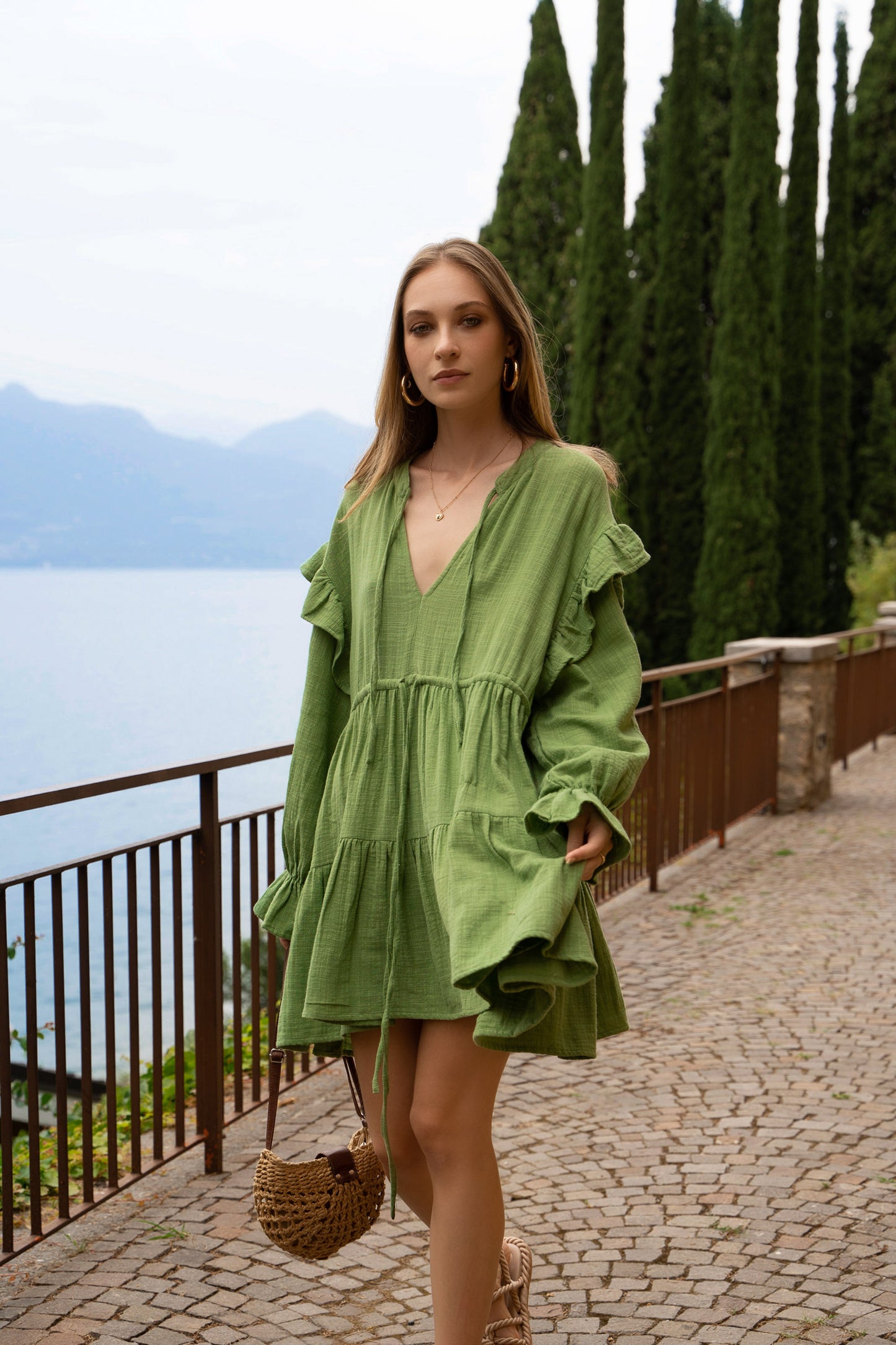 Green cotton dress, with long puff sleeves, wrist frills cuffs, wide tiered skirt.